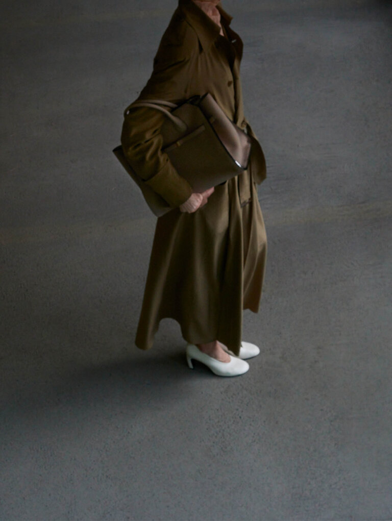 Woman wearing a Milano two handle bag in beige brown colour  soft suede leather