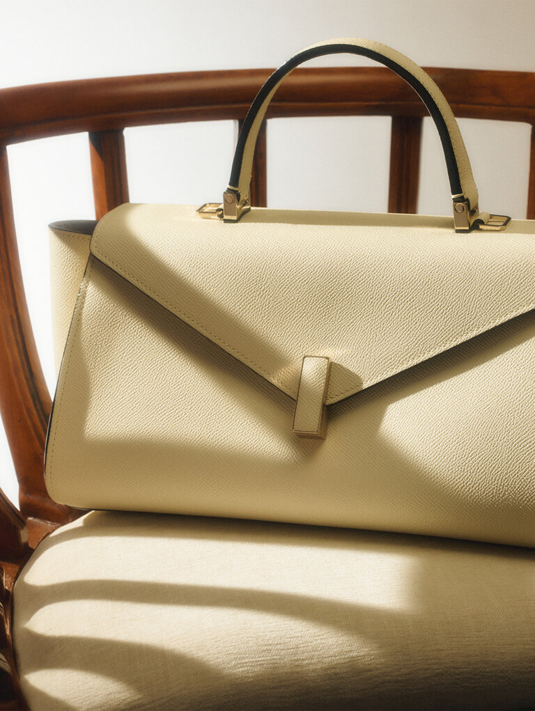 lextra Iside leather handbag in pergamena white ivory, the Maison's iconic Made in Italy handbag.