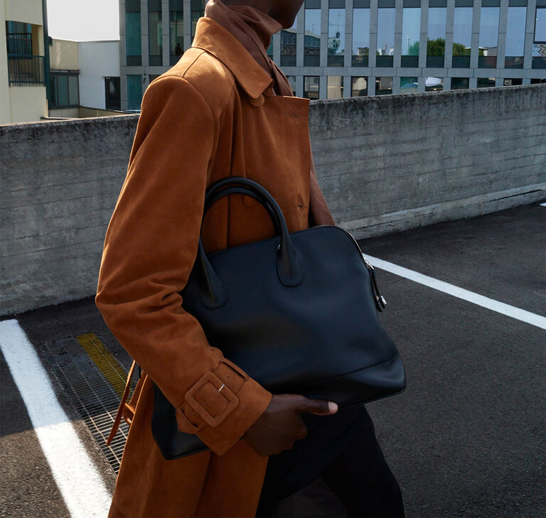 Woman carring a valextra mylogo bowling bag in black smooth leather